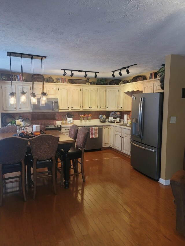 47 Hickory Ln, Sugar Tree, TN 38380 - kitchen with appliances with stainless steel finishes, dark wood-type flooring, light countertops, and a textured ceiling