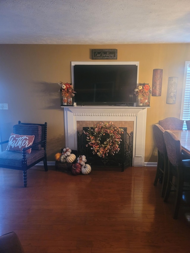 47 Hickory Ln, Sugar Tree, TN 38380 - living room with wood finished floors, a premium fireplace, baseboards, and a textured ceiling