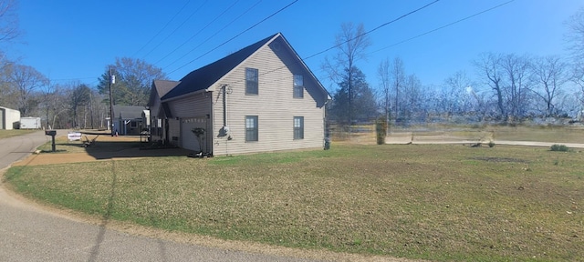 47 Hickory Ln, Sugar Tree, TN 38380 - view of side of home featuring a lawn and an attached garage