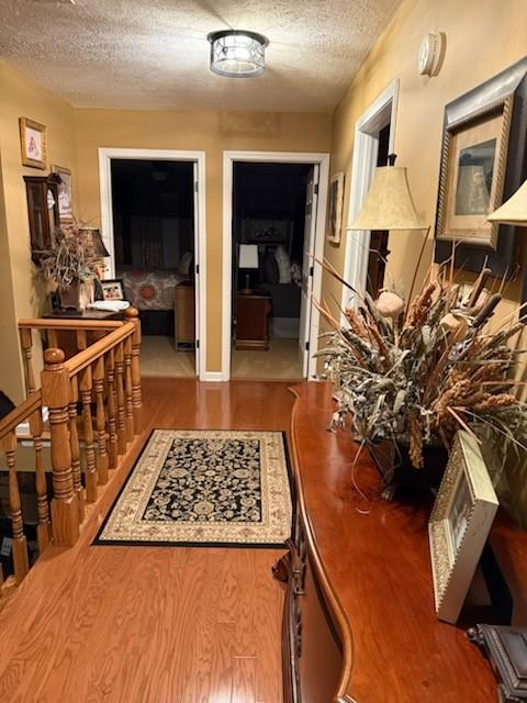 47 Hickory Ln, Sugar Tree, TN 38380 - hall with a textured ceiling and wood finished floors