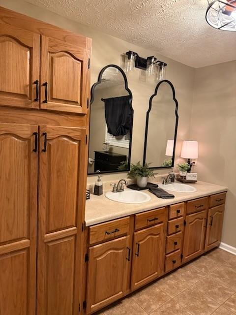 47 Hickory Ln, Sugar Tree, TN 38380 - full bathroom featuring a textured ceiling, double vanity, and tile patterned flooring