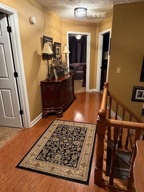 47 Hickory Ln, Sugar Tree, TN 38380 - hallway with a textured ceiling, wood finished floors, and baseboards
