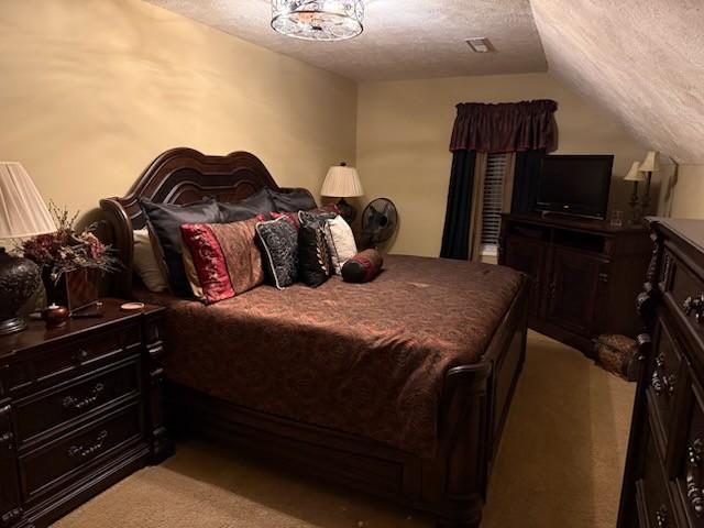 47 Hickory Ln, Sugar Tree, TN 38380 - bedroom with a textured ceiling, light carpet, and lofted ceiling