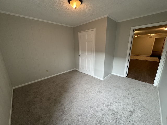 unfurnished bedroom with a closet, a textured ceiling, carpet flooring, and crown molding