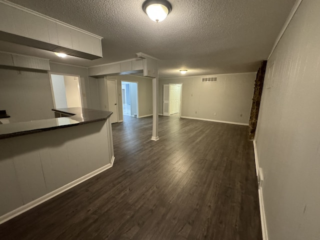 interior space featuring a textured ceiling and dark hardwood / wood-style floors