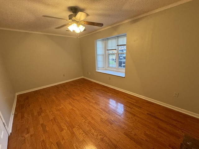 spare room with ceiling fan, a textured ceiling, light wood-type flooring, and crown molding