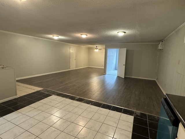 empty room featuring ornamental molding, hardwood / wood-style floors, a textured ceiling, and ceiling fan