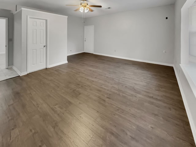 spare room with ceiling fan and dark hardwood / wood-style floors