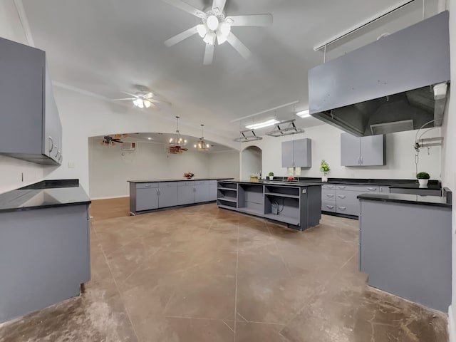 kitchen with ventilation hood, gray cabinetry, pendant lighting, and a kitchen island