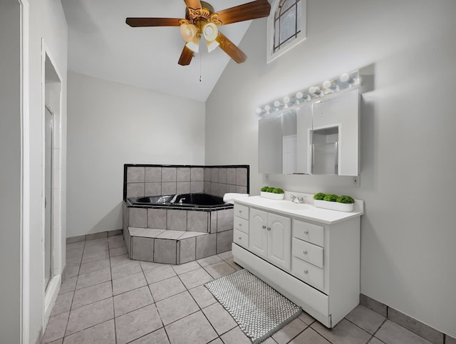 bathroom featuring tile patterned flooring, tiled tub, high vaulted ceiling, vanity, and ceiling fan