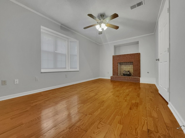 unfurnished living room featuring a fireplace, ornamental molding, and light hardwood / wood-style flooring