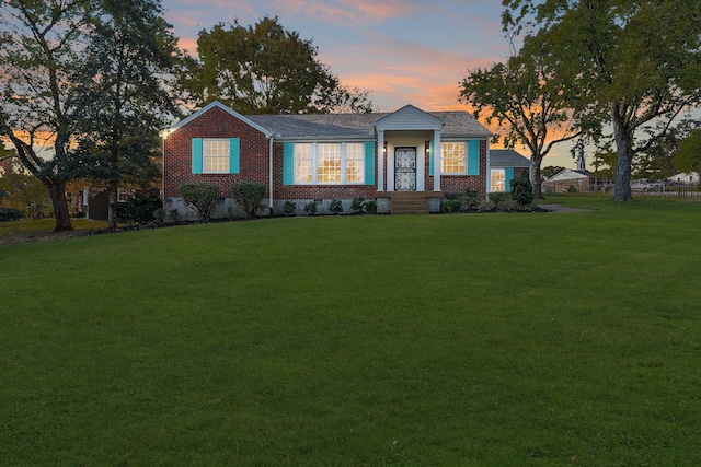 view of front of home with a yard