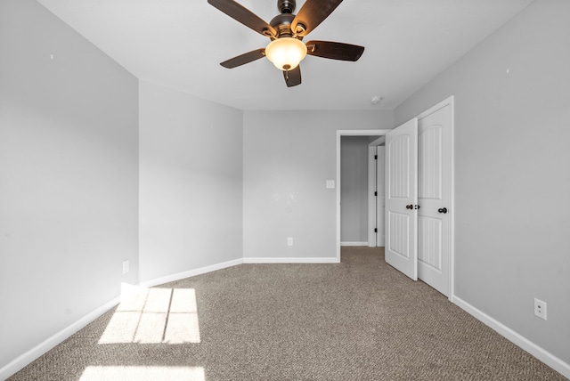 unfurnished bedroom with ceiling fan and carpet