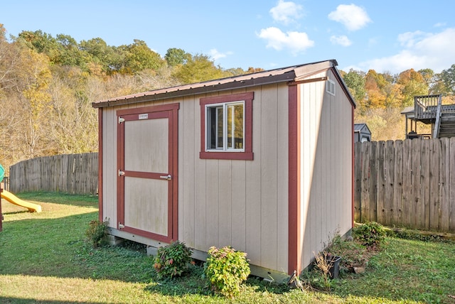 view of outbuilding with a lawn and a playground