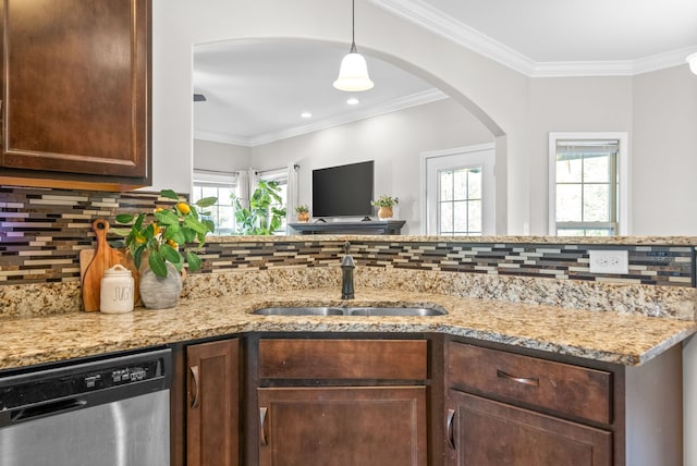 kitchen featuring backsplash, ornamental molding, sink, light stone countertops, and stainless steel dishwasher