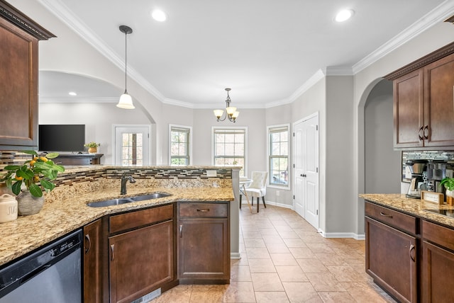 kitchen with stainless steel dishwasher, sink, pendant lighting, and tasteful backsplash