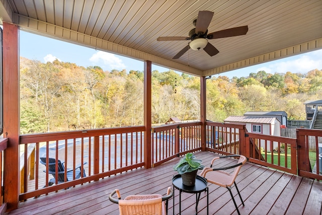 wooden terrace featuring a storage unit and ceiling fan