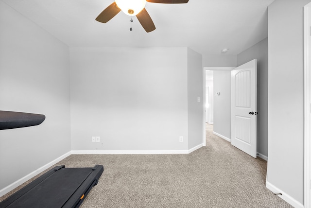 workout room with carpet and ceiling fan