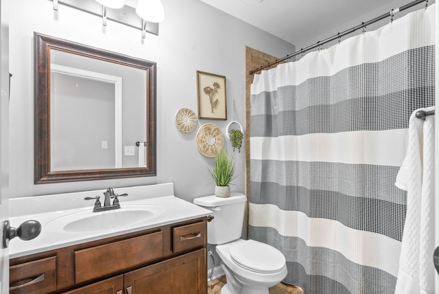 bathroom featuring vanity, a shower with curtain, and toilet