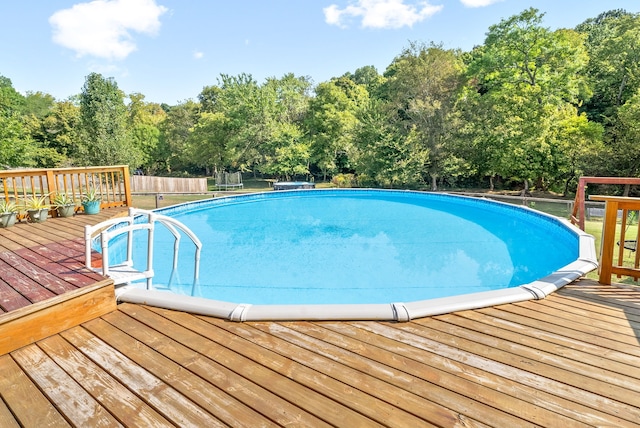 view of swimming pool featuring a deck