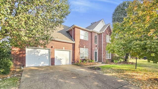 view of front of home with a front yard and a garage