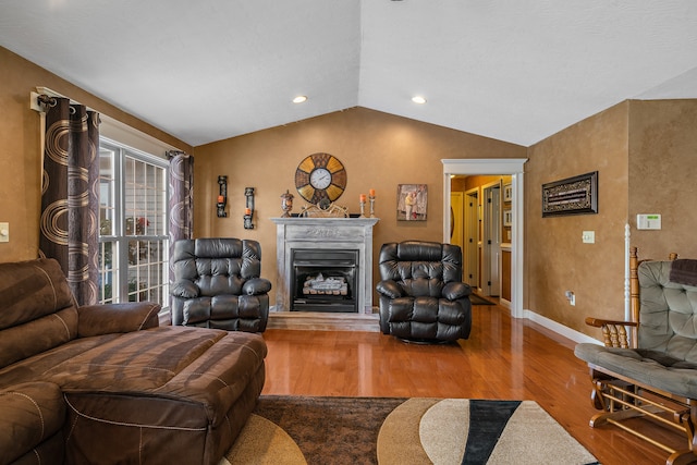 living room with wood-type flooring and vaulted ceiling