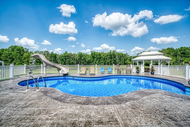 view of pool with a gazebo, a water slide, and a patio