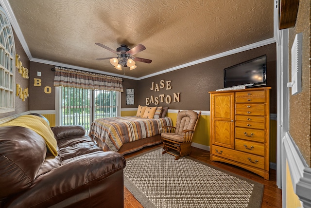 bedroom featuring ornamental molding, a textured ceiling, wood-type flooring, and ceiling fan