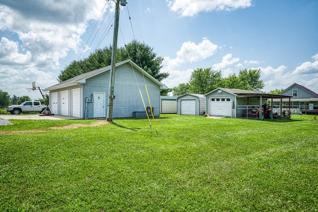 view of yard with a garage and an outdoor structure