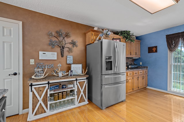 kitchen with appliances with stainless steel finishes and light wood-type flooring