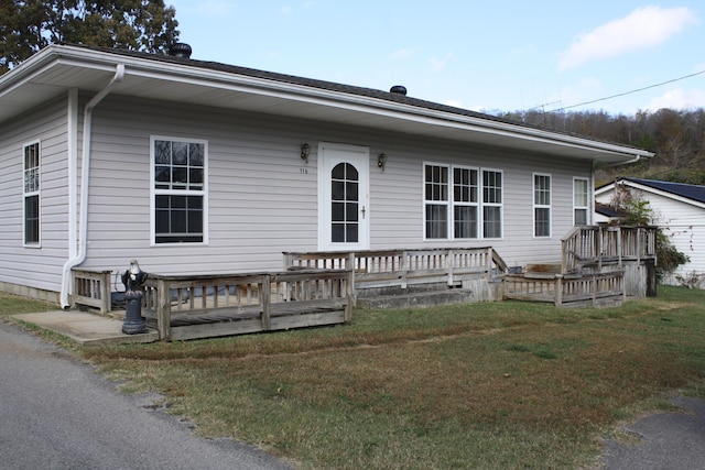 view of front of house with a front yard and a deck