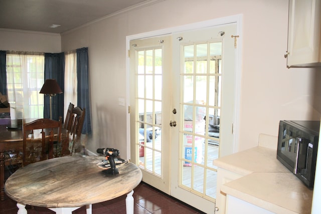 doorway with dark tile patterned flooring, ornamental molding, and french doors