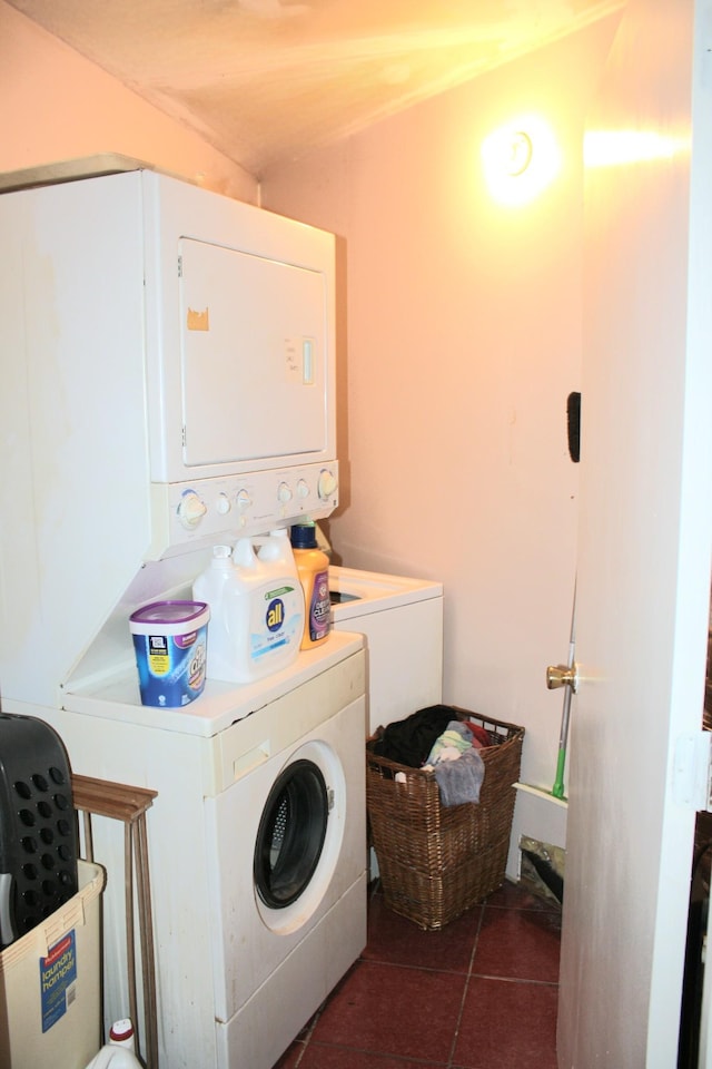 laundry room with laundry area, stacked washer / dryer, and tile patterned floors