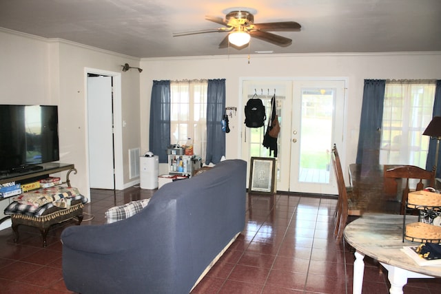 living room featuring crown molding, french doors, dark tile patterned floors, and ceiling fan