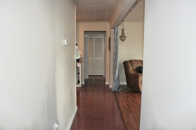 corridor featuring crown molding and baseboards