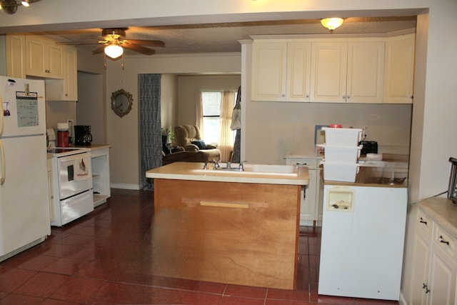 kitchen with dark tile patterned flooring, ceiling fan, and white appliances