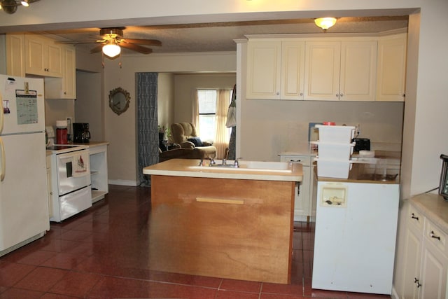 kitchen with dark tile patterned flooring, light countertops, ceiling fan, and white appliances