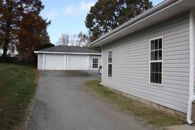 view of side of property featuring an outdoor structure and a detached garage