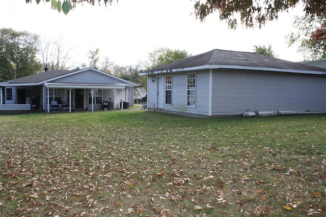back of house featuring a yard and central air condition unit