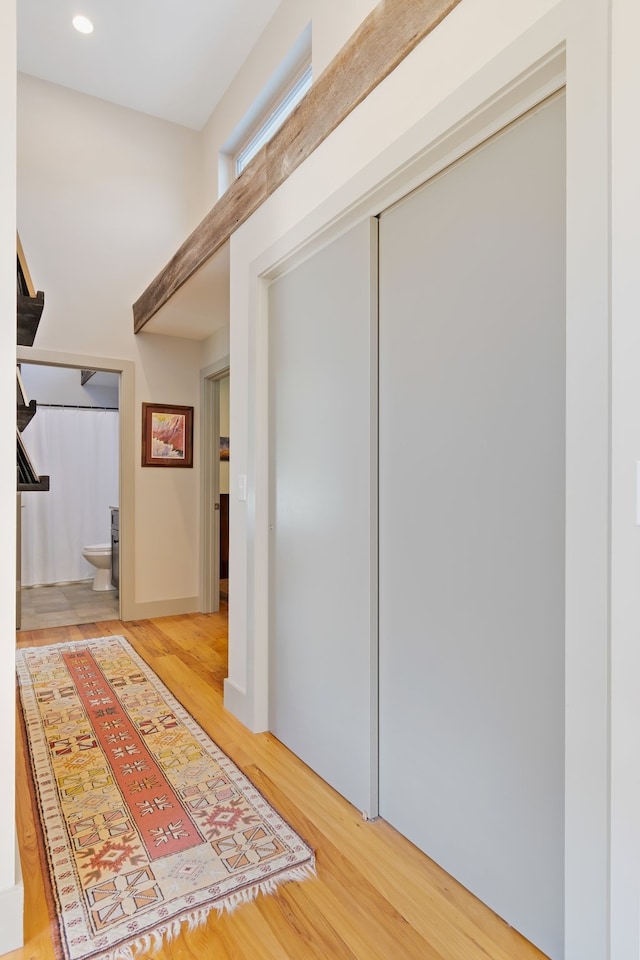 hall with hardwood / wood-style floors