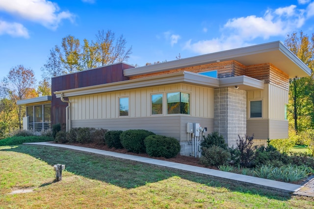 exterior space with a front lawn and a sunroom