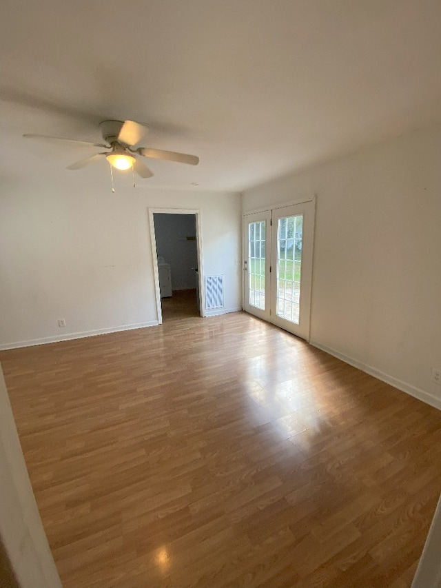 spare room with hardwood / wood-style flooring and ceiling fan