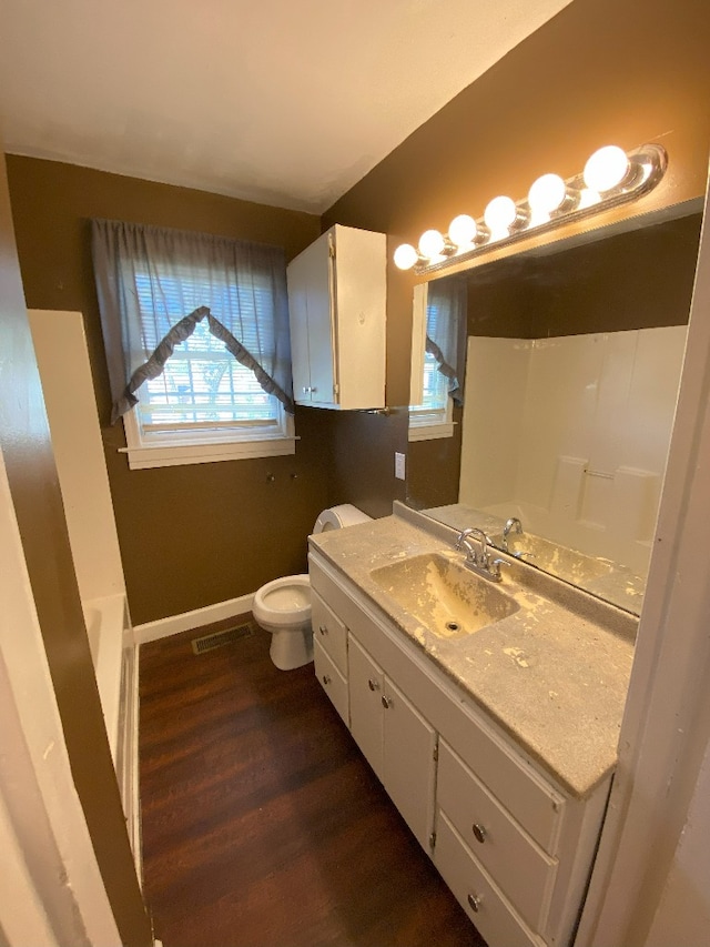 full bathroom with vanity, toilet, wood-type flooring, and shower with separate bathtub