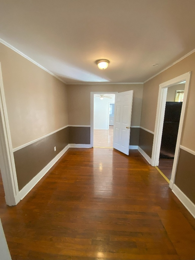 unfurnished room featuring crown molding and dark hardwood / wood-style flooring