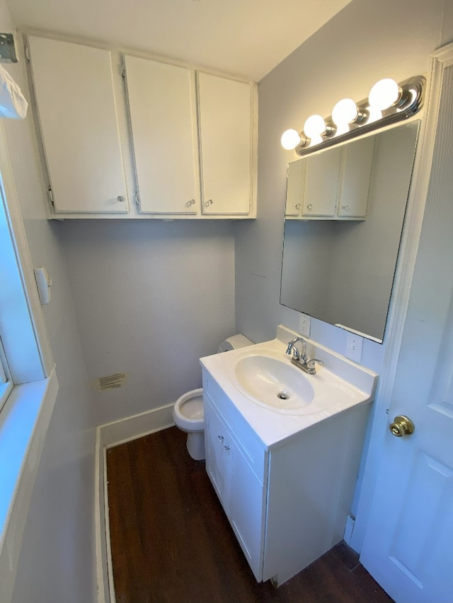 bathroom with vanity, hardwood / wood-style floors, and toilet