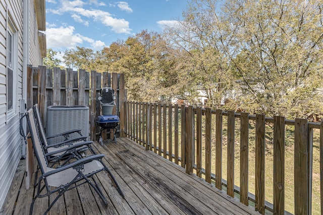 wooden deck featuring cooling unit