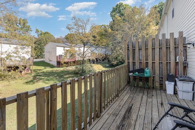 wooden terrace with a lawn