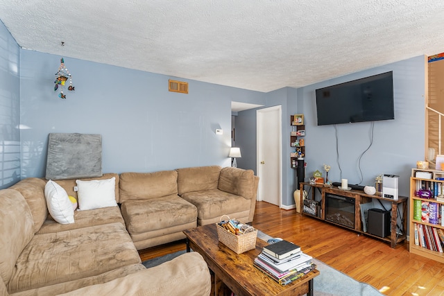 living room featuring hardwood / wood-style floors and a textured ceiling