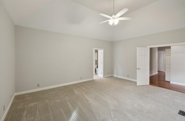 unfurnished bedroom featuring carpet flooring, a spacious closet, and ceiling fan