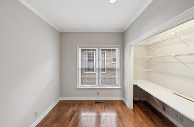 interior space with wood-type flooring and crown molding